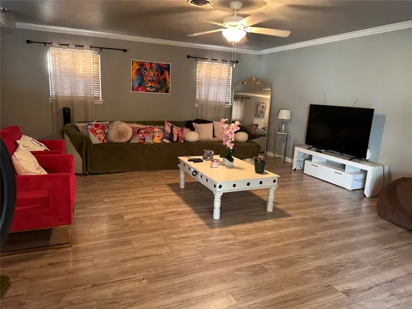 a living room with furniture and a flat screen tv