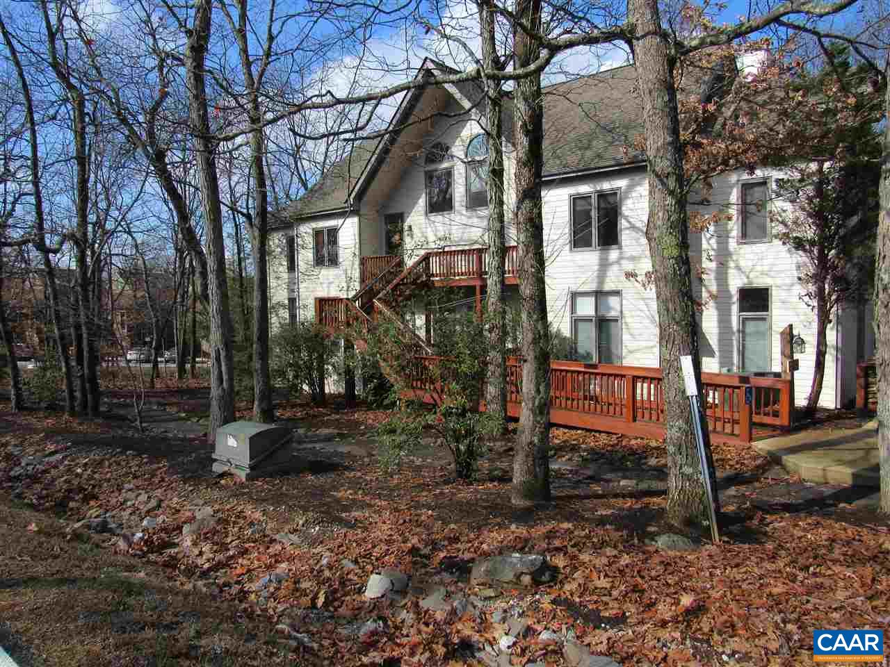 a view of a house with a yard siting area and tree