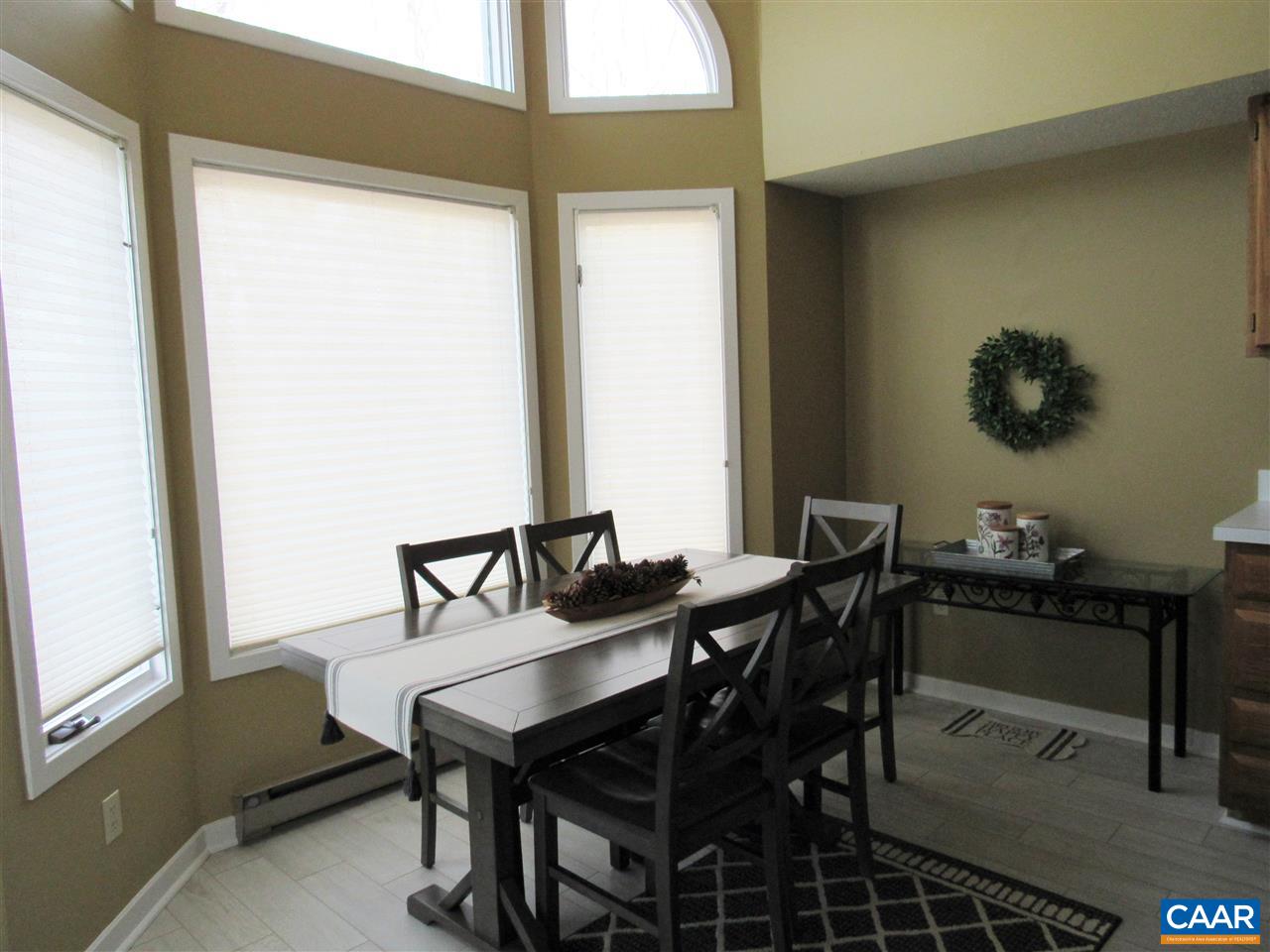 2002 Stone Rdg Wds, Unit 2002 Wintergreen, VA 22967 - Photo 13 of 22 a view of a dining room with furniture and window