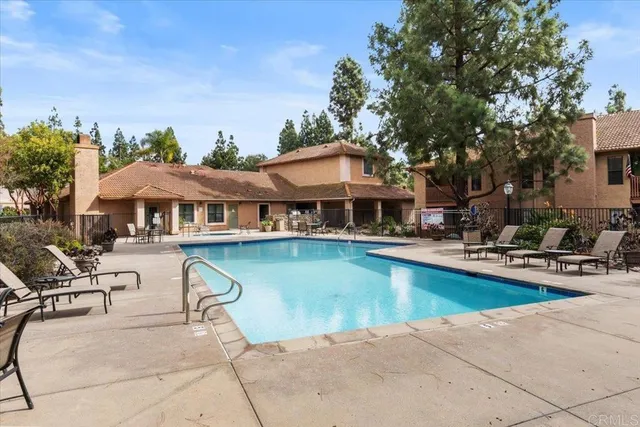 a swimming pool with outdoor seating and yard