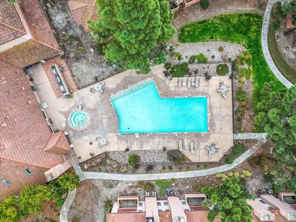 an aerial view of a house with a yard and green space
