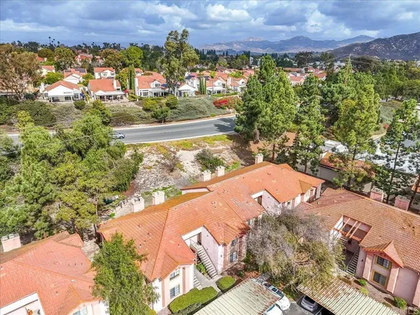 an aerial view of residential houses with city and lake view