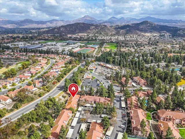 an aerial view of residential building with green space