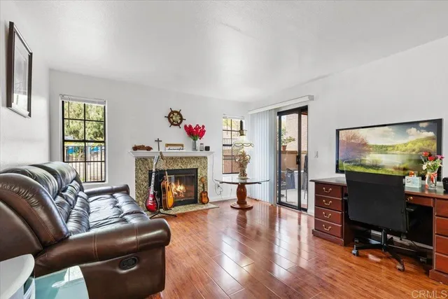 a living room with furniture a fireplace and a flat screen tv