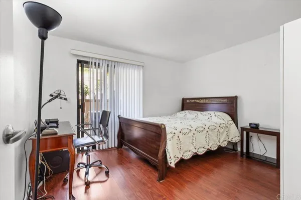 a bedroom with a bed a table and chair