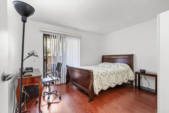 a bedroom with a bed a table and chair