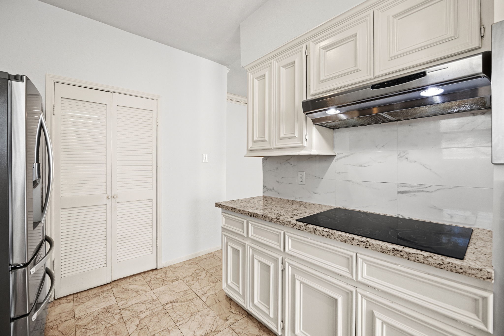8043 Oceanside Drive Houston, TX 77095 - Photo 13 of 41 a kitchen with stainless steel appliances granite countertop a refrigerator and a stove