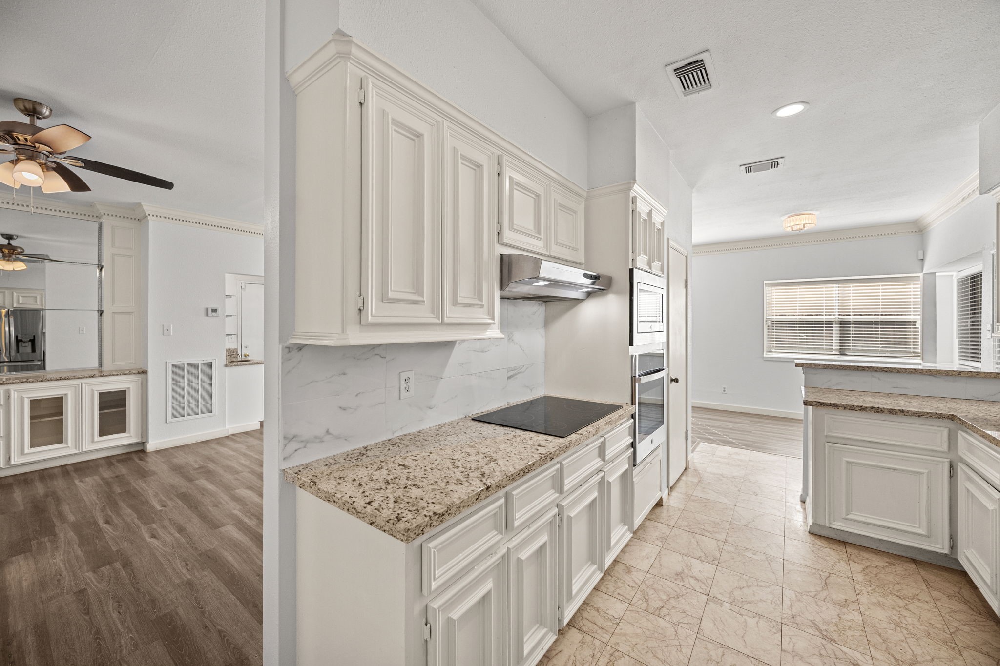 8043 Oceanside Drive Houston, TX 77095 - Photo 15 of 41 a kitchen with stainless steel appliances kitchen island granite countertop a sink and cabinets
