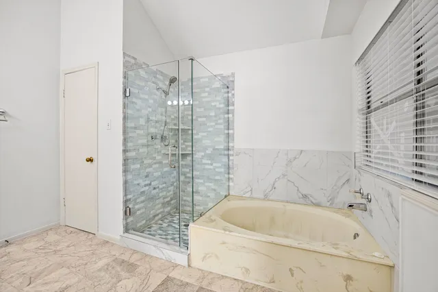 a bathroom with a bathtub and shower