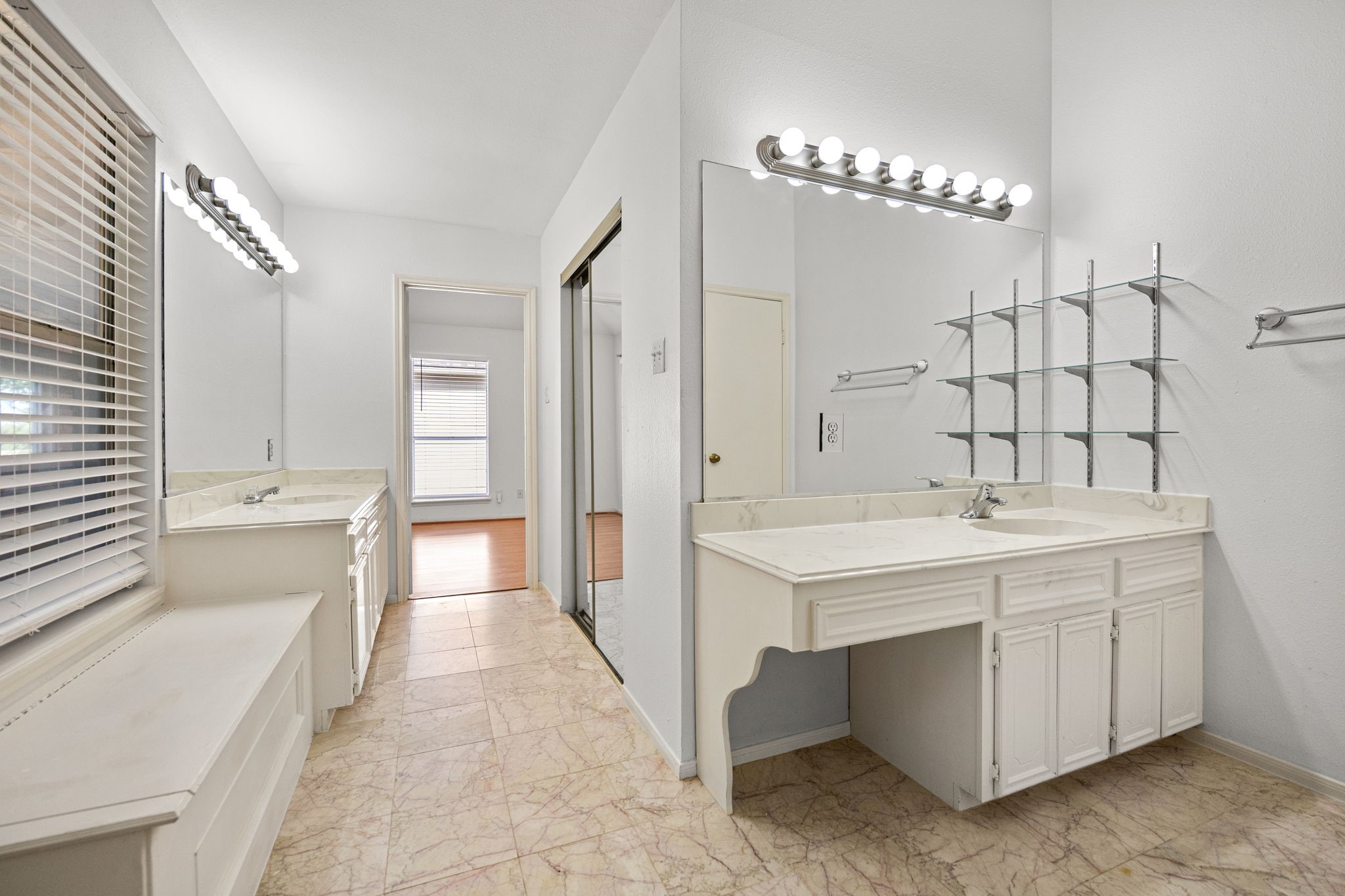 8043 Oceanside Drive Houston, TX 77095 - Photo 22 of 41 a spacious bathroom with a double vanity sink a large mirror and a bathtub