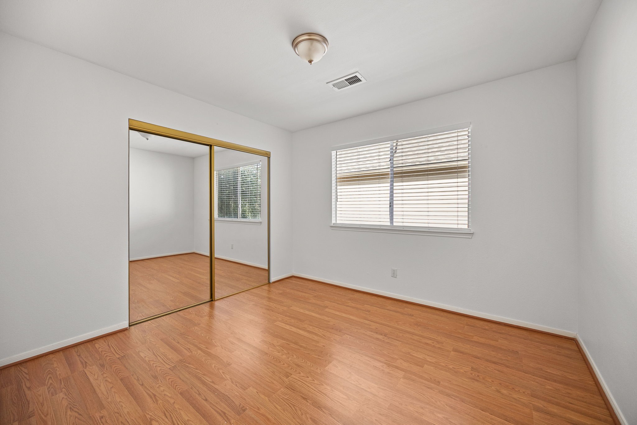 8043 Oceanside Drive Houston, TX 77095 - Photo 24 of 41 an empty room with wooden floor and windows