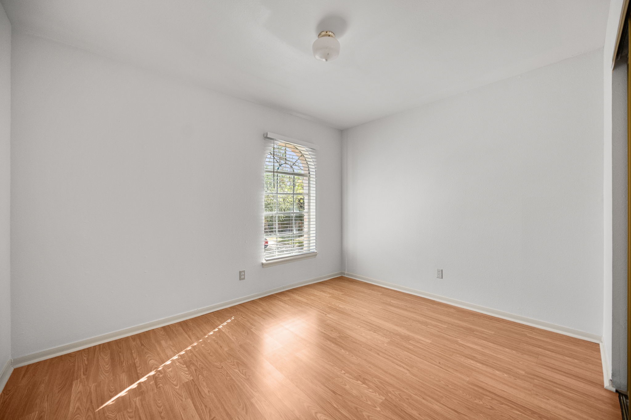 8043 Oceanside Drive Houston, TX 77095 - Photo 26 of 41 an empty room with wooden floor and windows