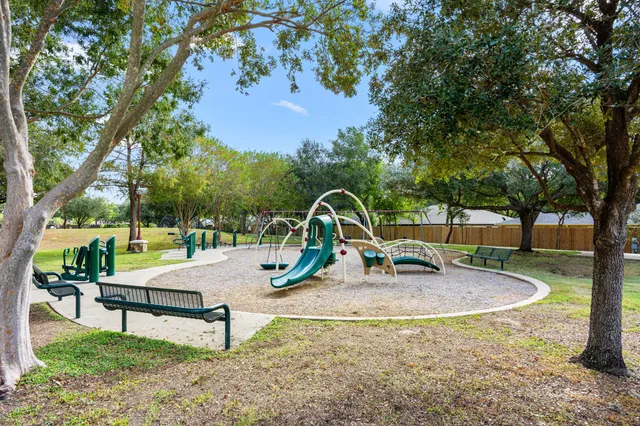 a view of outdoor space with playground and green space