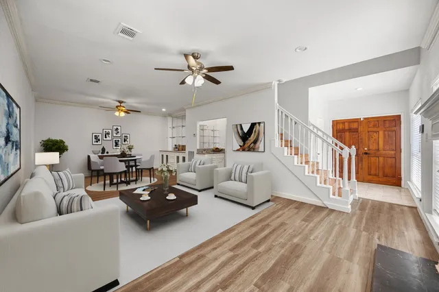 a living room with furniture and wooden floor