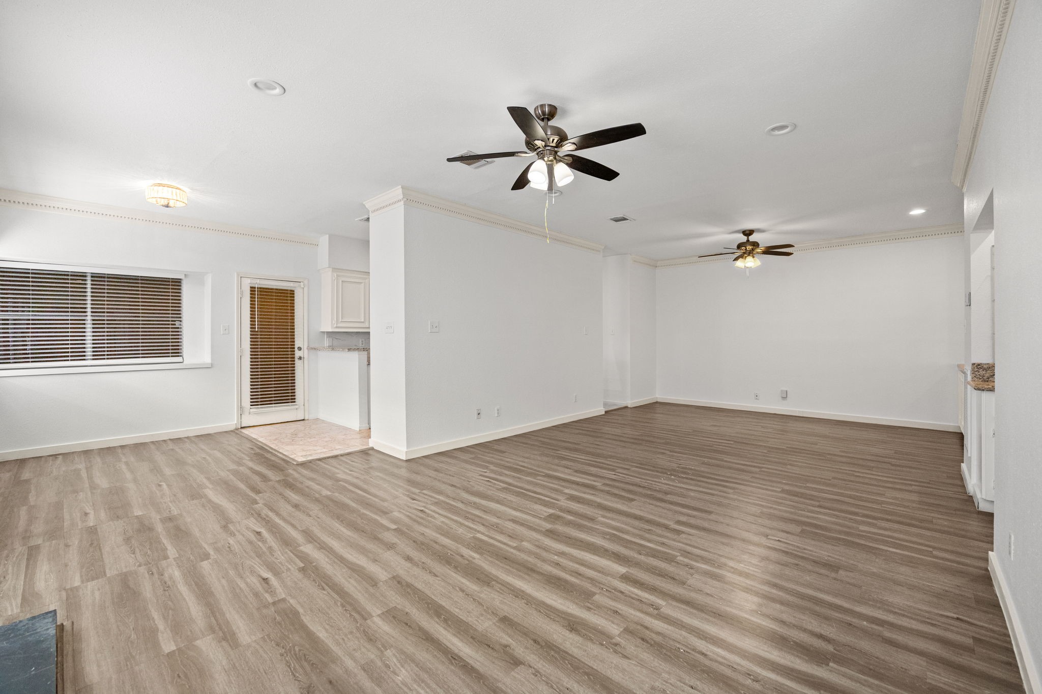 8043 Oceanside Drive Houston, TX 77095 - Photo 7 of 41 a view of empty room with wooden floor and fan