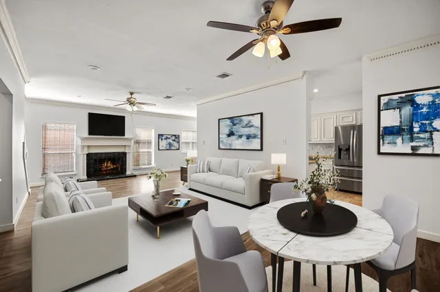 a living room with furniture a fireplace and a flat screen tv