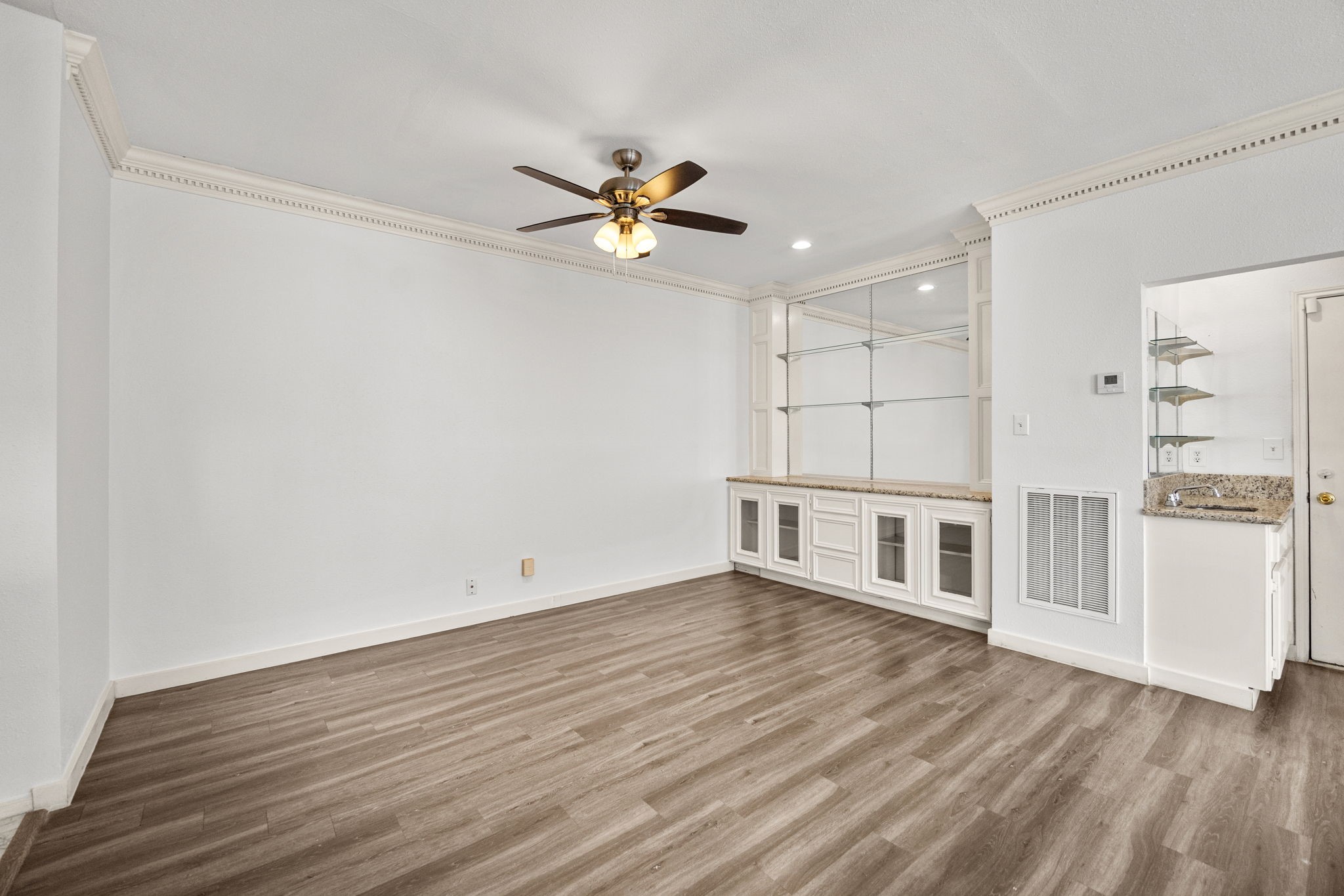 8043 Oceanside Drive Houston, TX 77095 - Photo 10 of 41 a view of a room with wooden floor and a ceiling fan