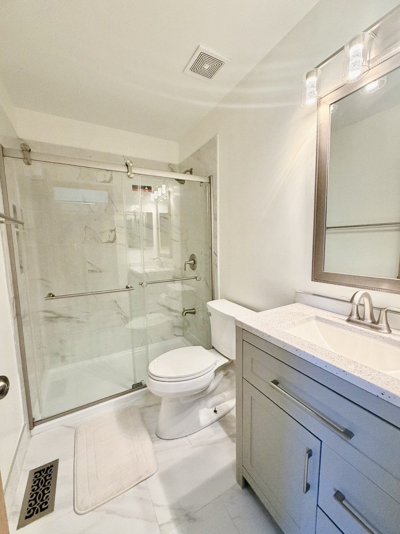 4 Haverton Court Streamwood, IL 60107 - Photo 15 of 30 a bathroom with a sink a toilet and shower