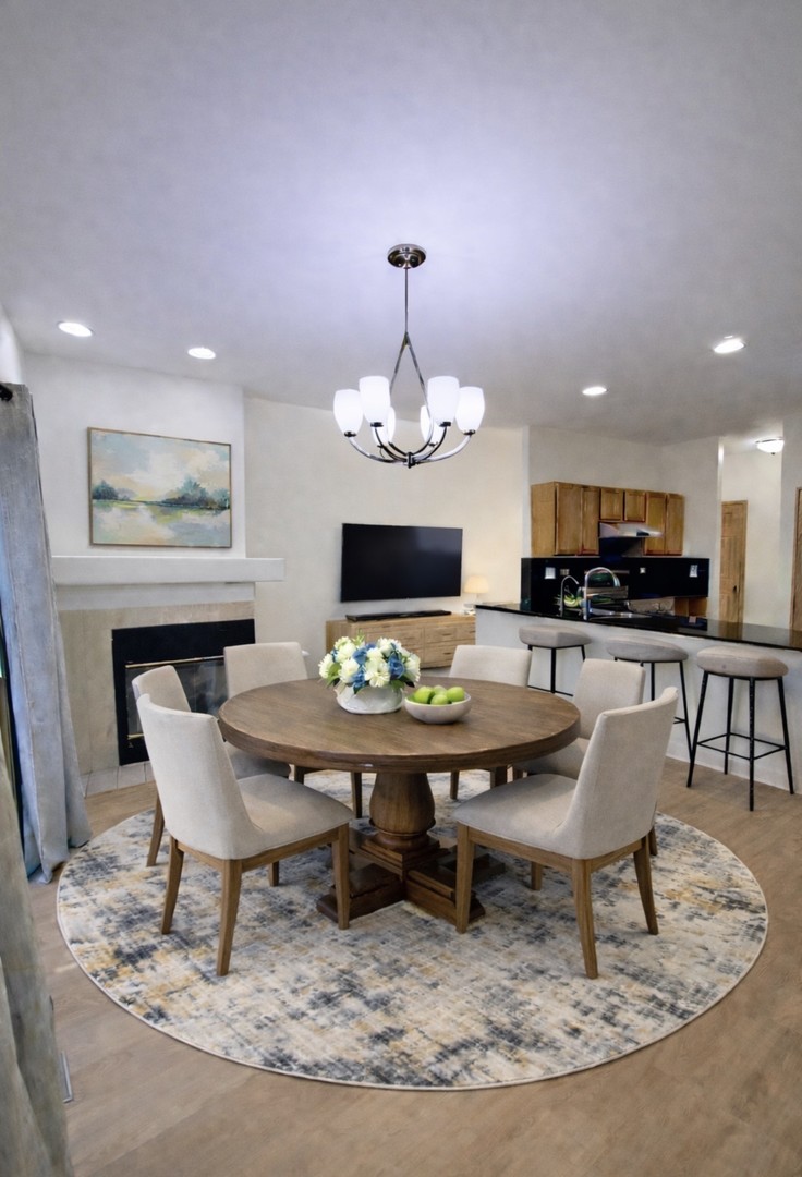 4 Haverton Court Streamwood, IL 60107 - Photo 6 of 30 a living room with dining table and a chandelier