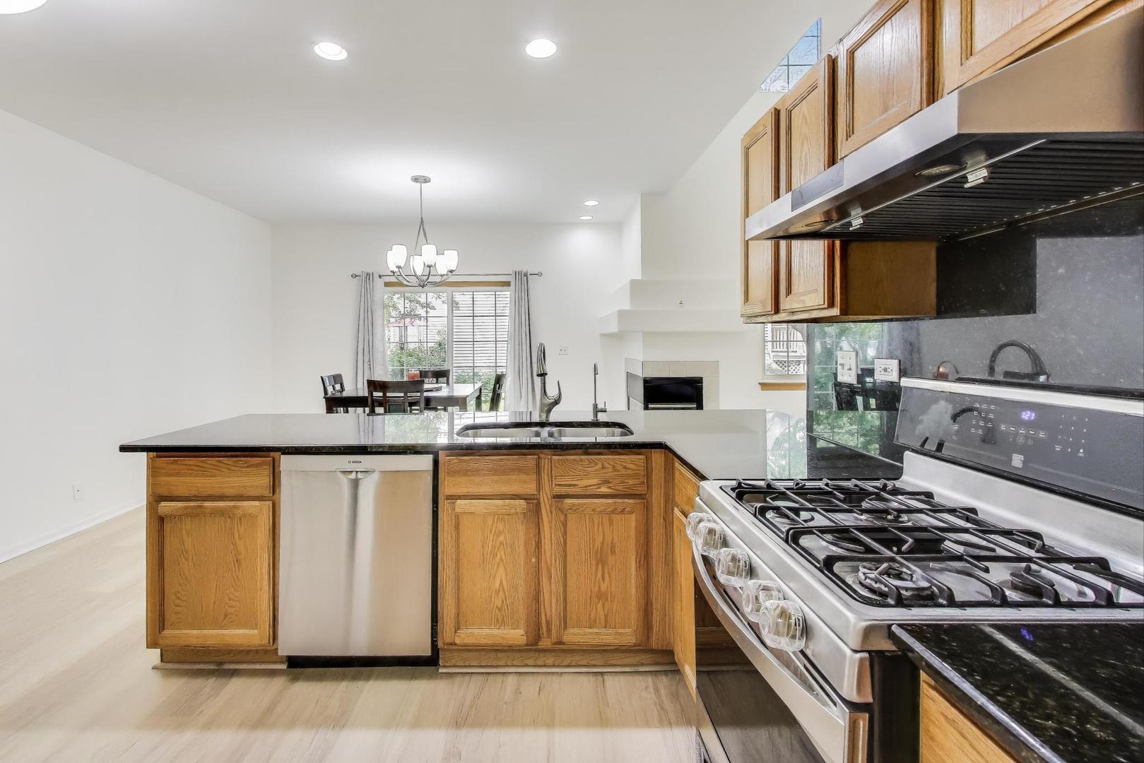 4 Haverton Court Streamwood, IL 60107 - Photo 9 of 30 a kitchen with stainless steel appliances granite countertop a stove a sink and a microwave