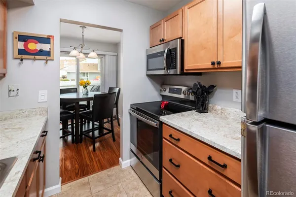 a kitchen with stainless steel appliances granite countertop a stove a sink and a refrigerator
