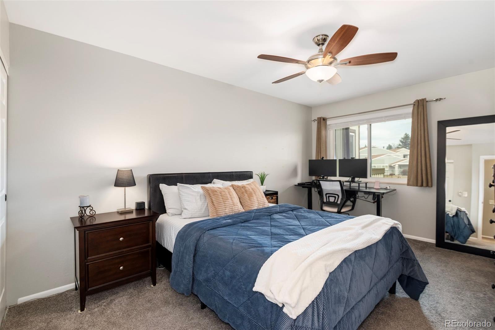 8751 Chase Drive, Unit 181 Arvada, CO 80003 - Photo 13 of 25 a bed room with a bed and a window
