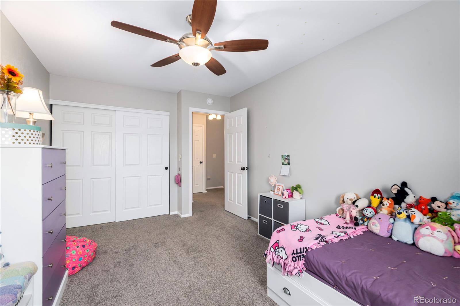 8751 Chase Drive, Unit 181 Arvada, CO 80003 - Photo 17 of 25 a bedroom with a bed and a chandelier