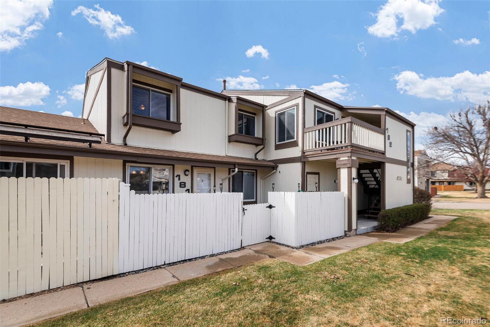 8751 Chase Drive, Unit 181 Arvada, CO 80003 - Photo 20 of 25 a view of a white building among the street with plants