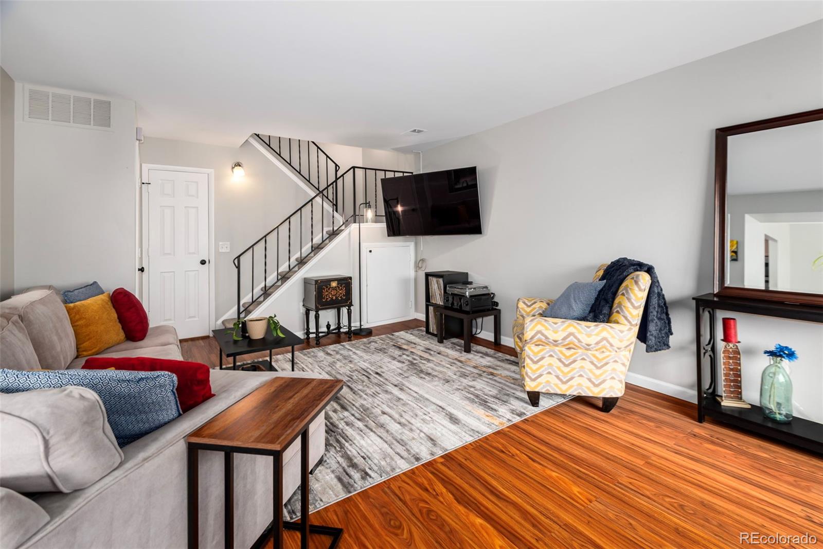 8751 Chase Drive, Unit 181 Arvada, CO 80003 - Photo 2 of 25 a living room with furniture and a flat screen tv
