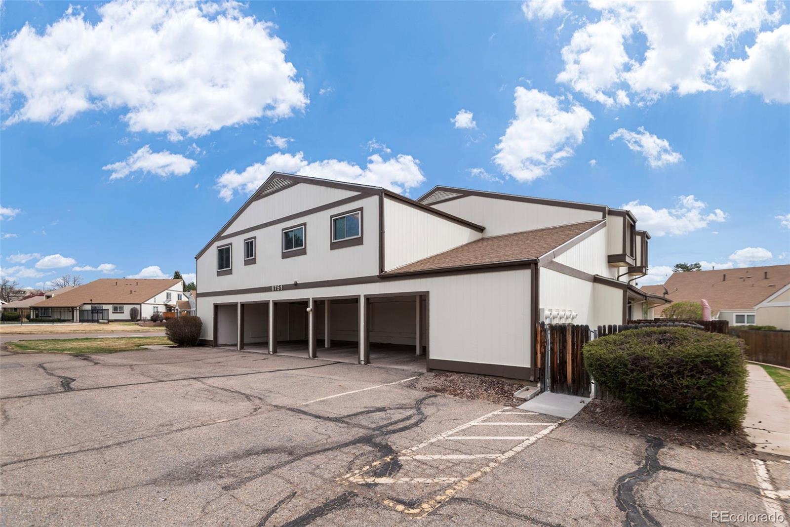 8751 Chase Drive, Unit 181 Arvada, CO 80003 - Photo 22 of 25 a view of a house with a backyard and a barbeque