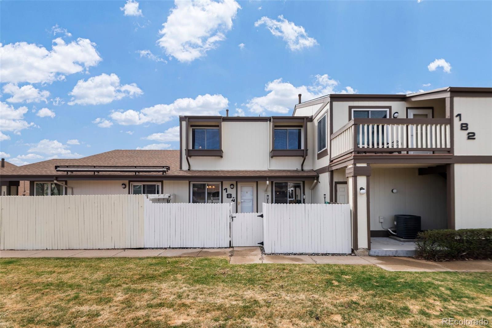 8751 Chase Drive, Unit 181 Arvada, CO 80003 - Photo 24 of 25 a front view of a house with a yard