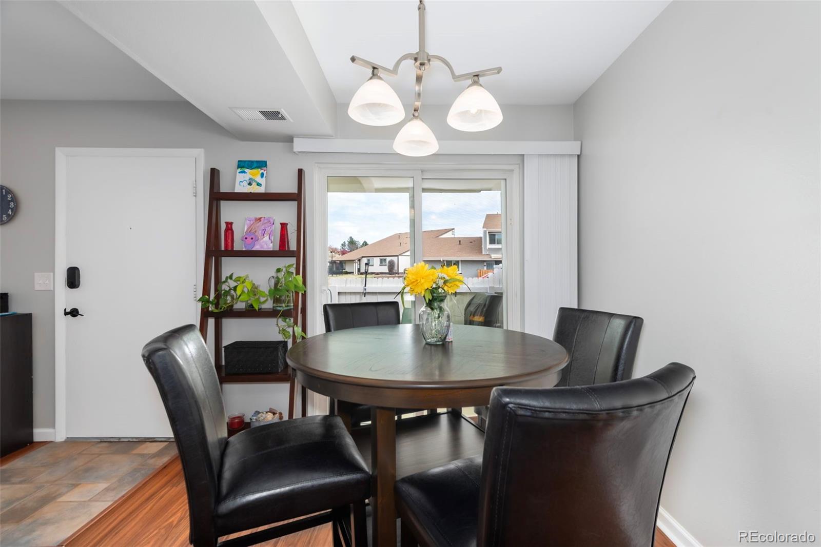 8751 Chase Drive, Unit 181 Arvada, CO 80003 - Photo 6 of 25 a view of a dining room with furniture and chandelier