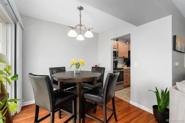 a view of a dining room with furniture wooden floor and chandelier