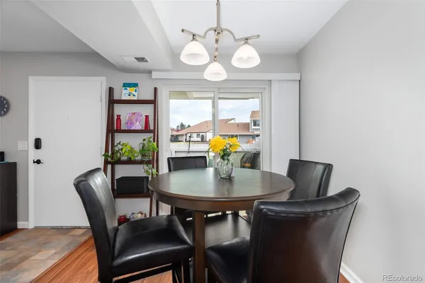 a view of a dining room with furniture and chandelier
