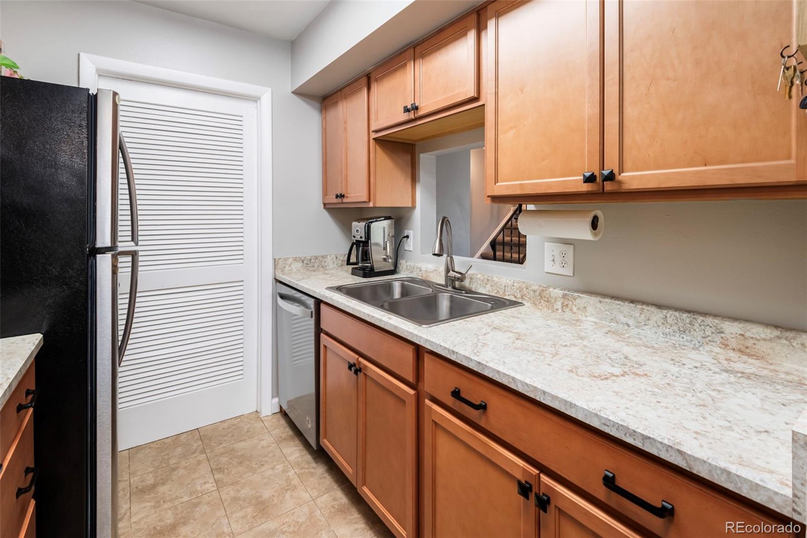 8751 Chase Drive, Unit 181 Arvada, CO 80003 - Photo 9 of 25 a kitchen with a sink and cabinets