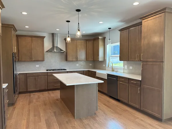 a kitchen with a sink refrigerator and cabinets
