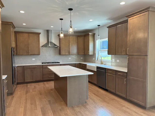 a kitchen with a sink refrigerator and cabinets