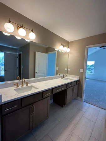 a bathroom with a double vanity sink and a mirror