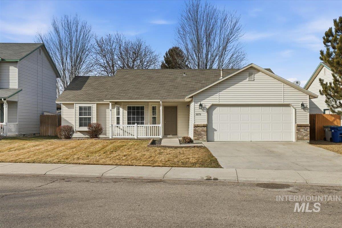 Single story home featuring a porch, concrete driveway, a garage, and brick siding