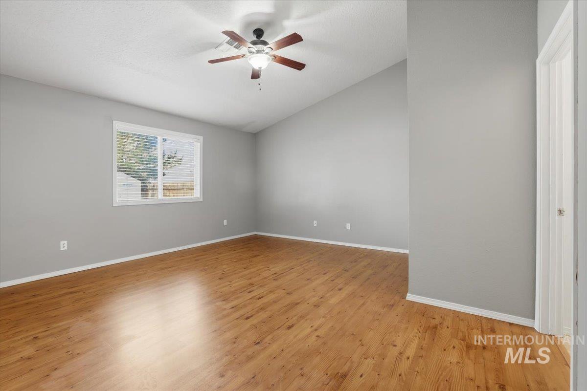 3273 North Chatterton Way Boise, ID 83713 - Photo 15 of 29 Master Bedroom with vaulted ceiling, light wood-style flooring, and ceiling fan