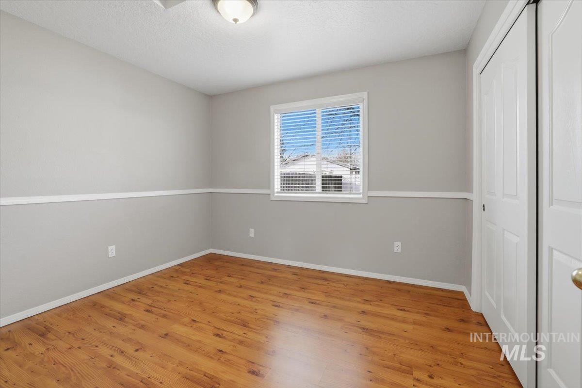 3273 North Chatterton Way Boise, ID 83713 - Photo 21 of 29 Unfurnished bedroom featuring a closet, light wood-type flooring, and a textured ceiling