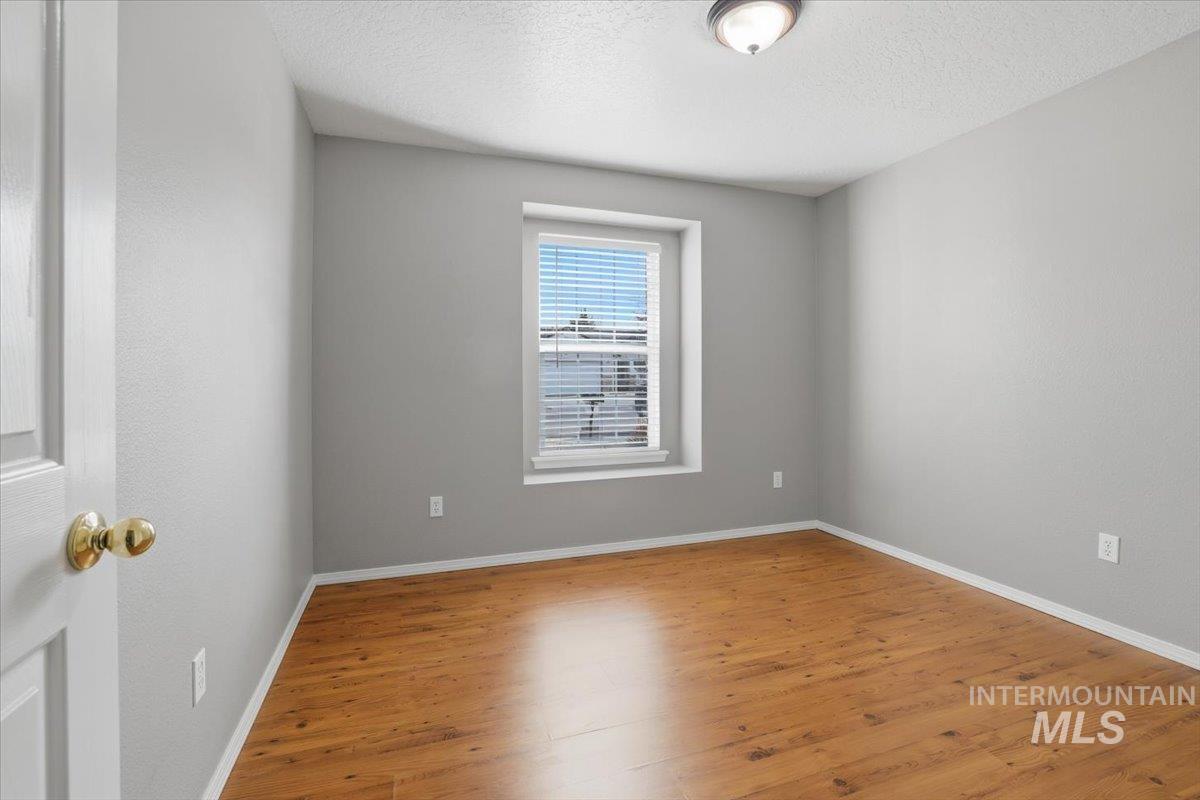 3273 North Chatterton Way Boise, ID 83713 - Photo 23 of 29 Front bedroom featuring wood finished floors and a textured ceiling