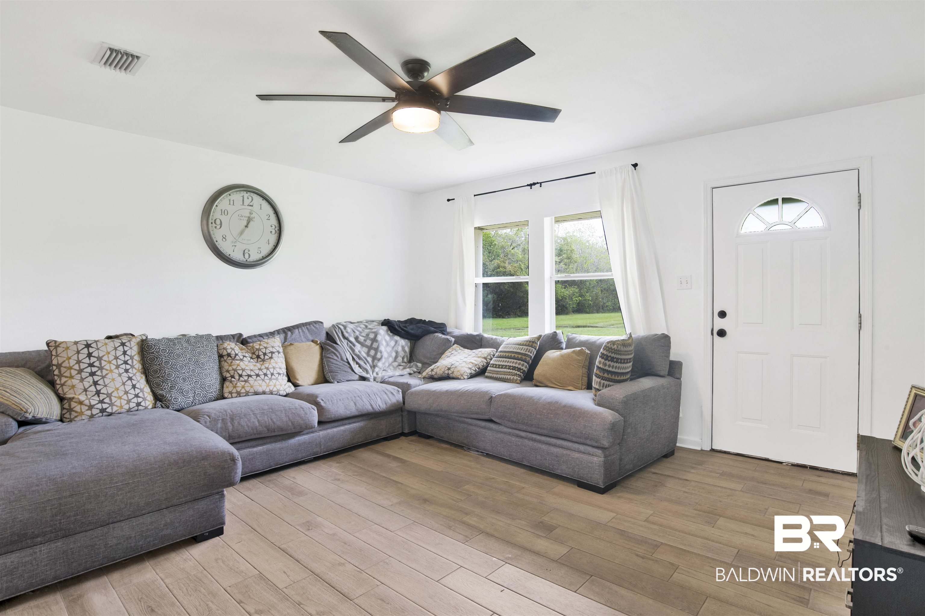 10244 Magnolia Road Irvington, AL 36544 - Photo 3 of 37 Living room featuring ceiling fan, visible vents, and light wood finished floors