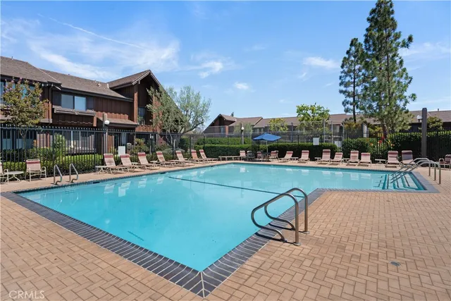 a view of a swimming pool with outdoor seating