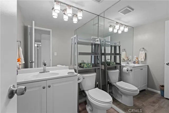 a bathroom with a toilet a sink and mirror