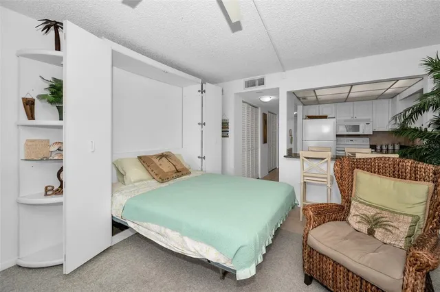 a bedroom with a bed window and couch