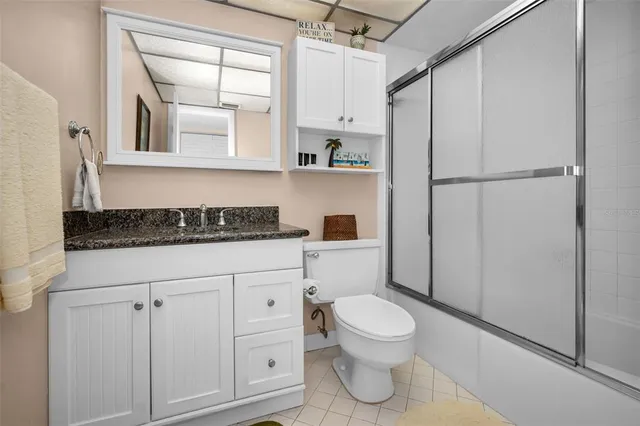 a bathroom with a toilet sink and a shower
