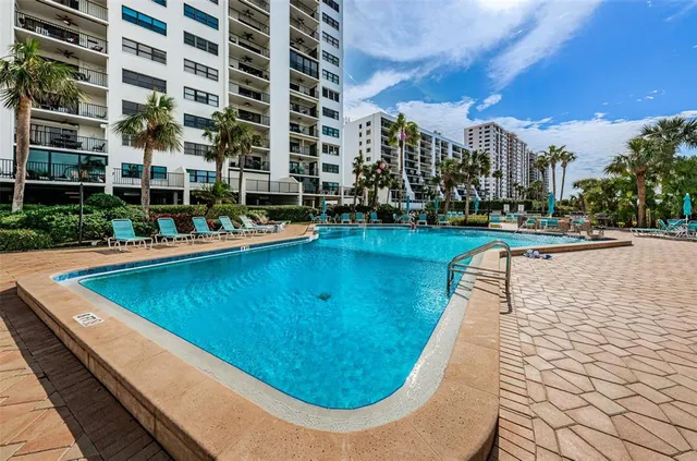 a view of a swimming pool with outdoor seating