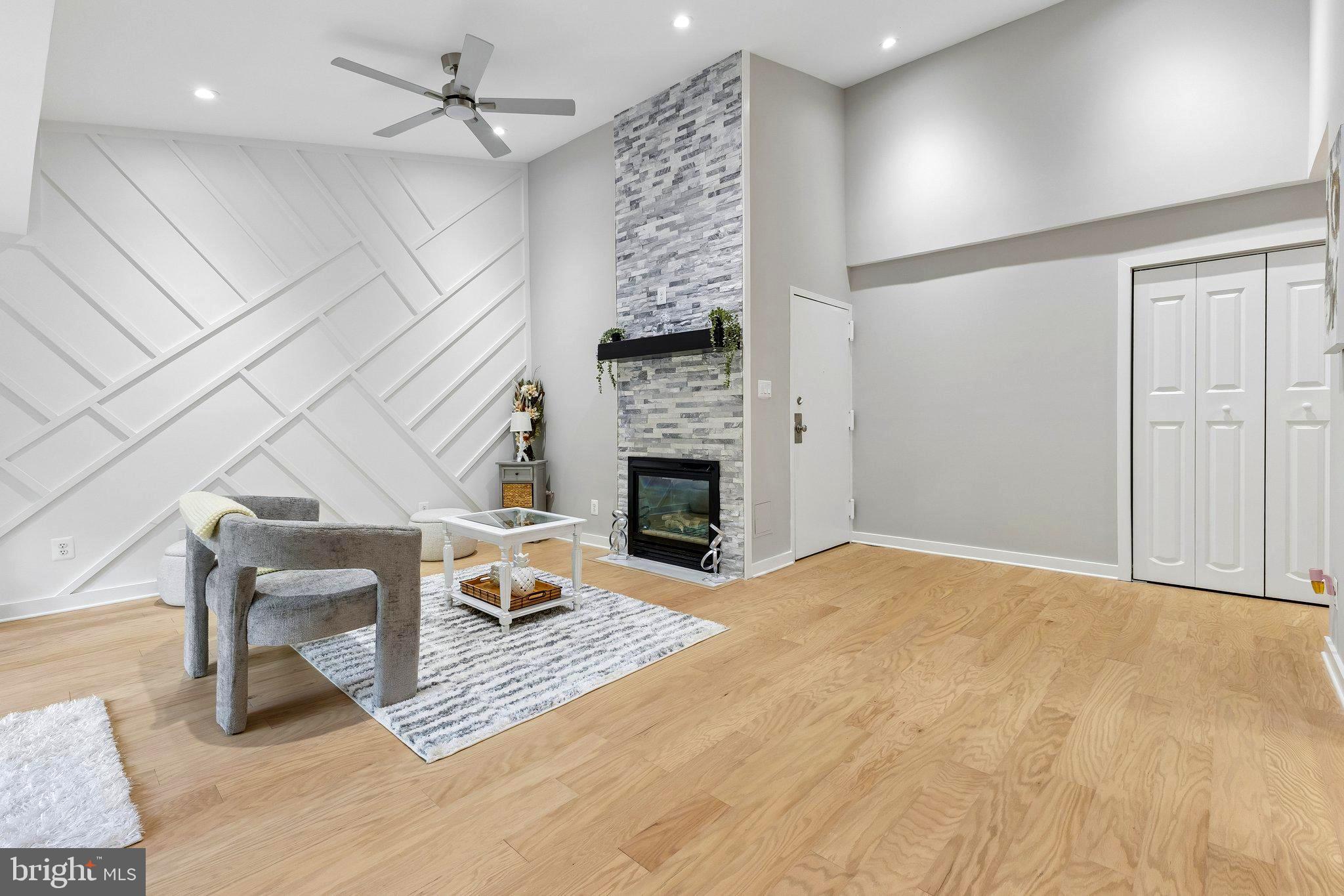 11841 Shire Court, Unit 31D Reston, VA 20191 - Photo 4 of 24 a living room with furniture a fireplace and a ceiling fan