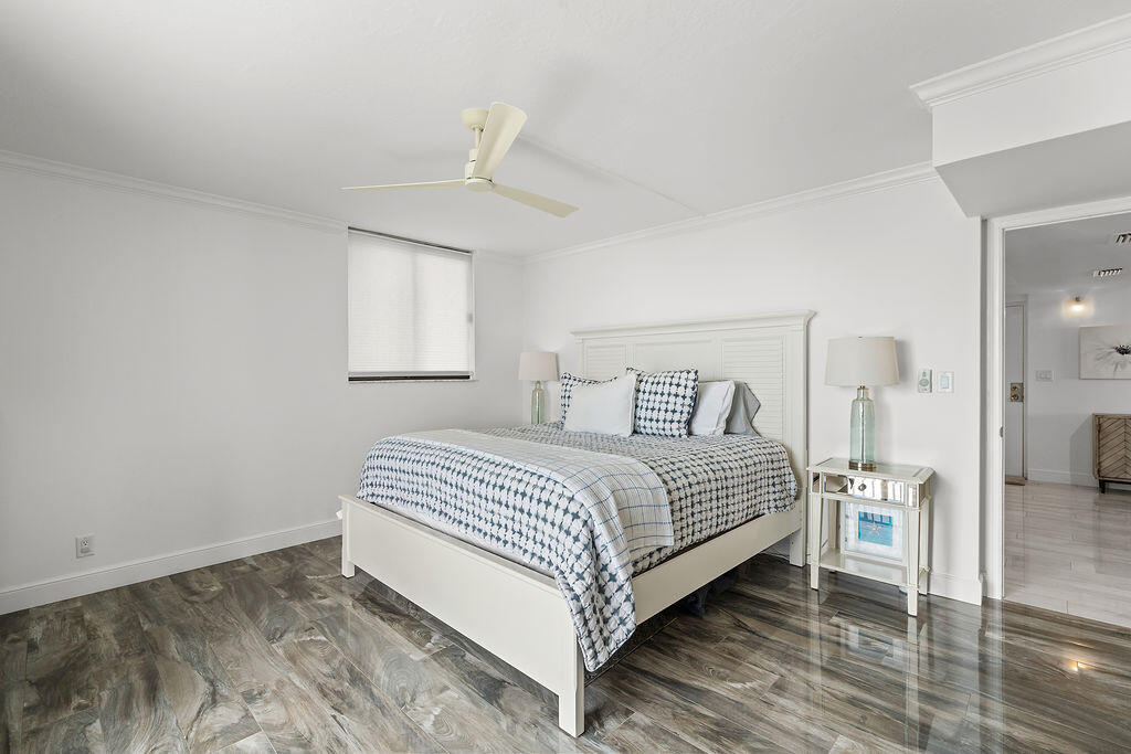 300 Ocean Trail Way, Unit 301 Jupiter, FL 33477 - Photo 20 of 64 a bedroom with a bed and a window